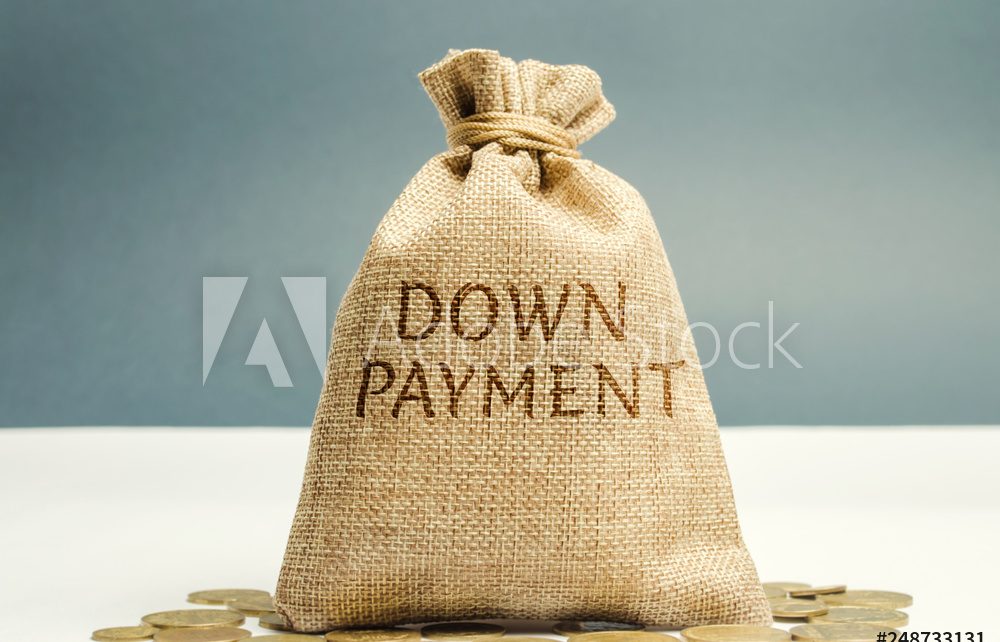 Money bag with the word down payment. Payment used in the context of the purchase of expensive items such as a car and a house, whereby the payment is the initial upfront portion of the total amount